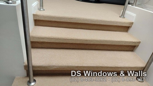 close-up of carpeted stair treads showing a clean wrapped edge